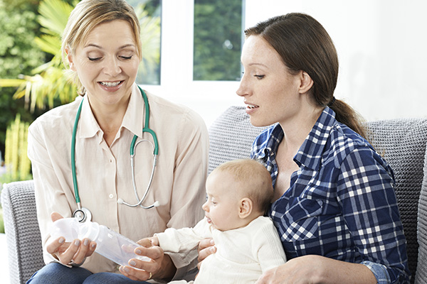 doctor with child patient and mother