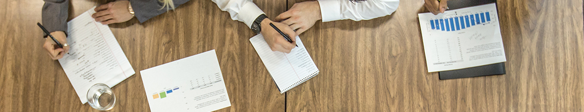 people in a meeting with papers around